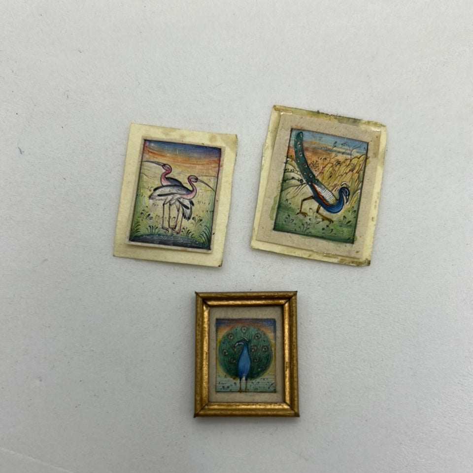 Miniature handmade birds and peacock colored drawings