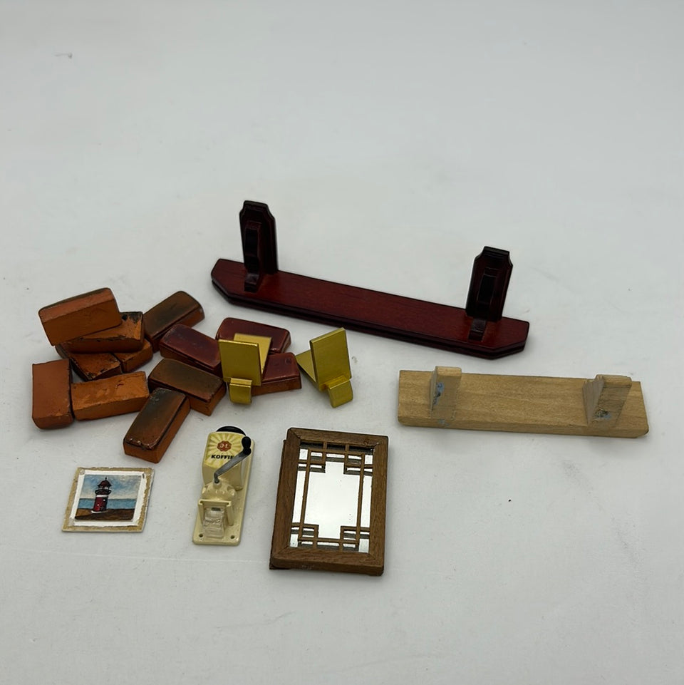 Miniature dollhouse set with a mirror, coffee grinder, painting, shelfs and bricks