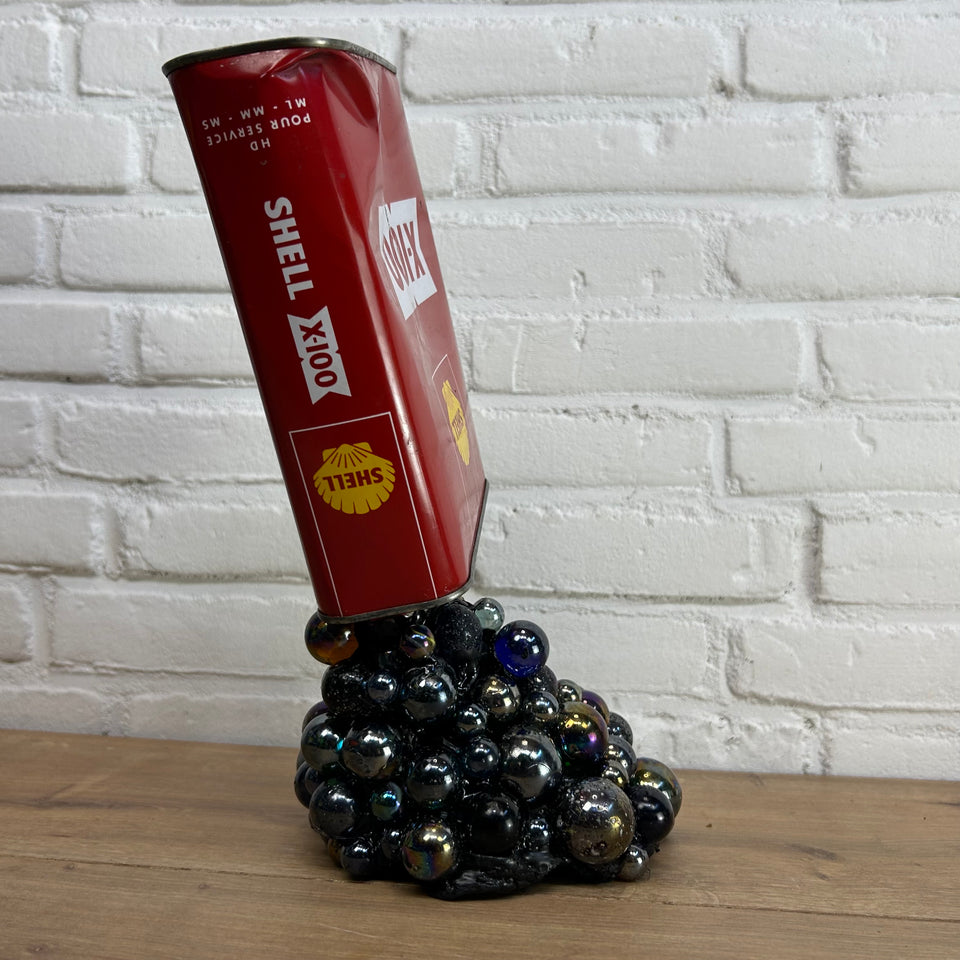 Shell oil can pouring Marbles statue