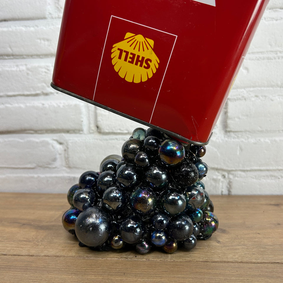 Shell oil can pouring Marbles statue