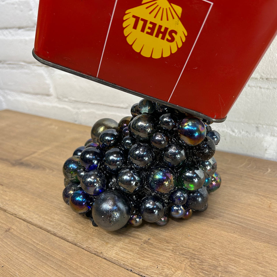 Shell oil can pouring Marbles statue
