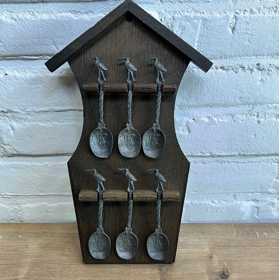 Antique wooden wall hanging with 6 old small Dutch tin spoons.
