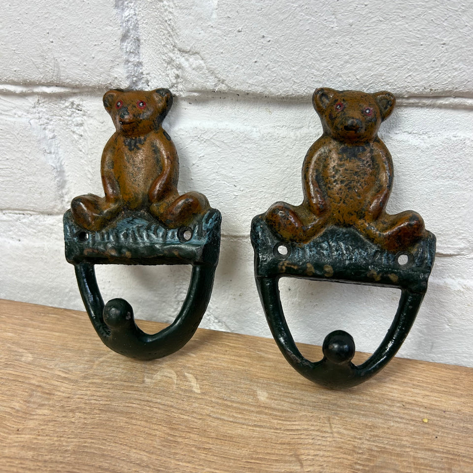 Antique cast-iron hangers with teddy bear for children’s room
