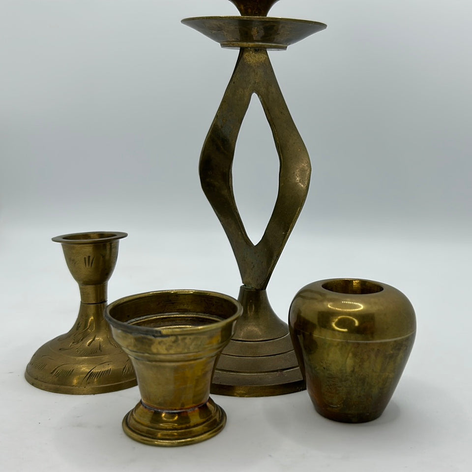 A set of 4 messing or copper candle holders