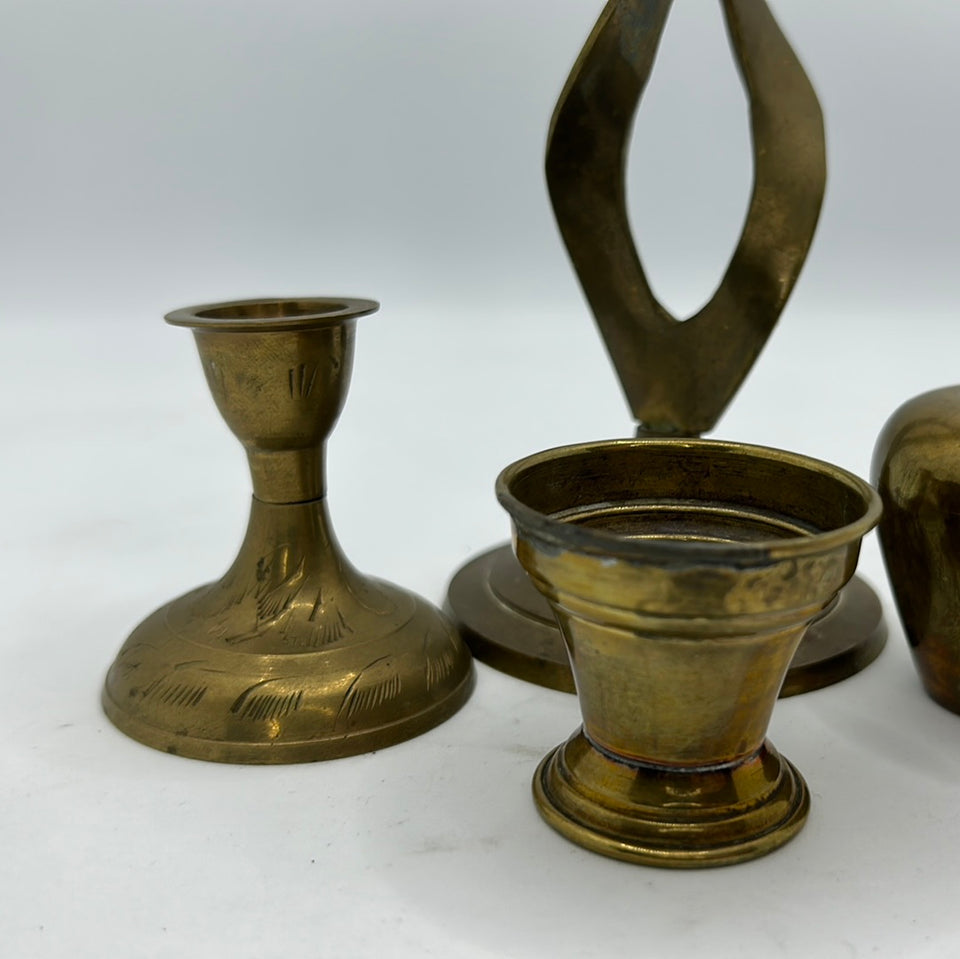 A set of 4 messing or copper candle holders
