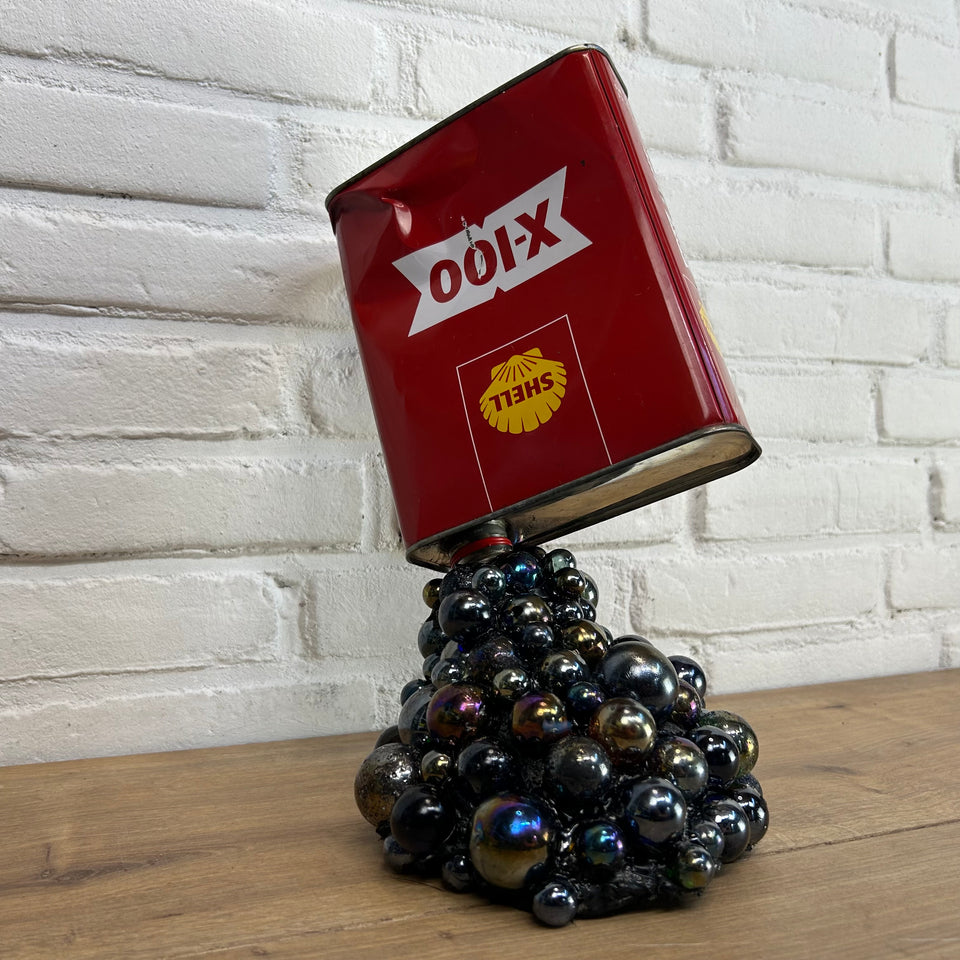 Shell oil can pouring Marbles statue