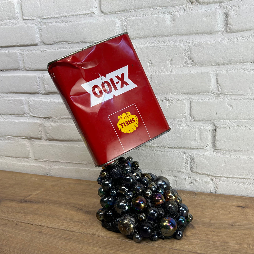 Shell oil can pouring Marbles statue