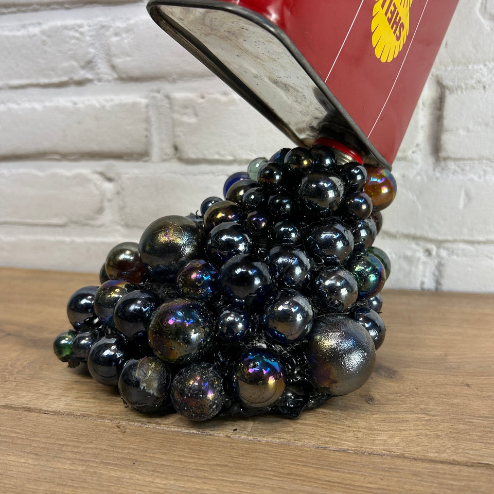 Shell oil can pouring Marbles statue