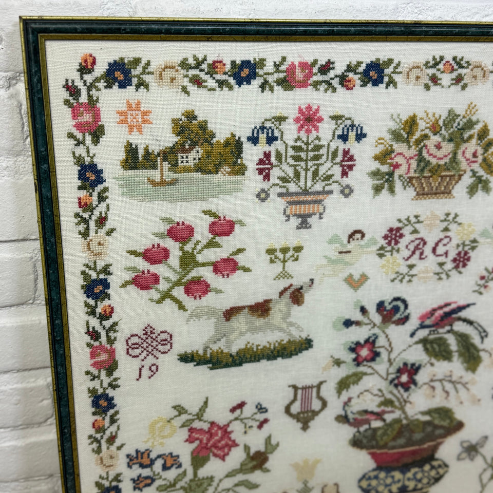 Large antique pattern Embroidery Sampler framed behind matt glass