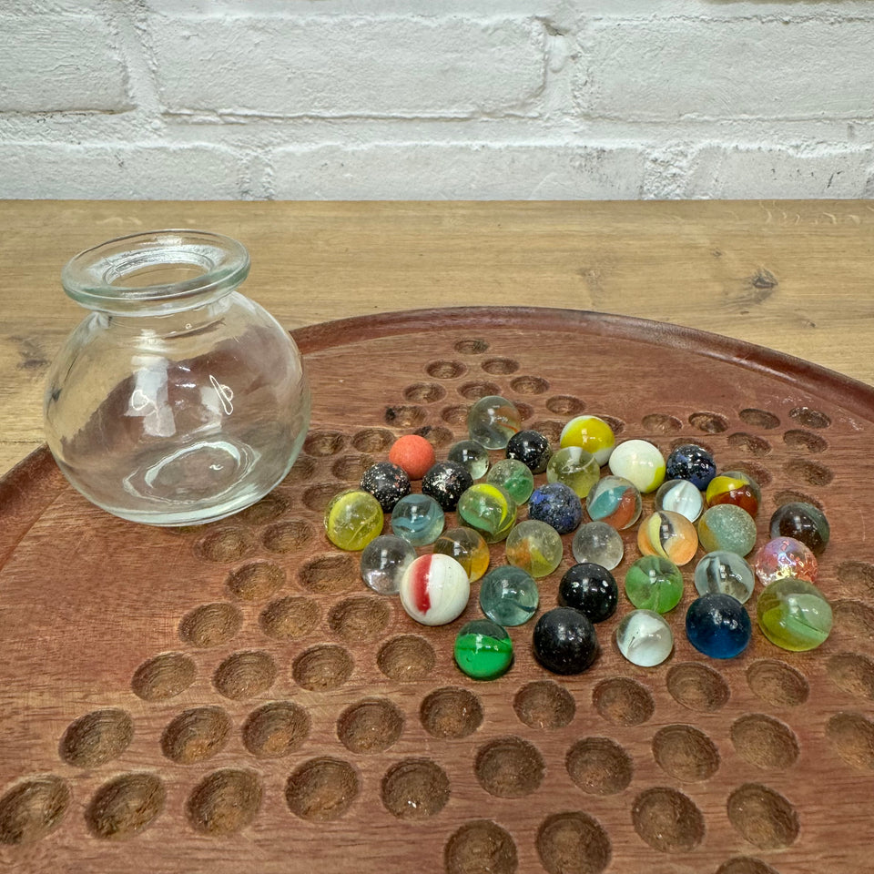 A miniature jar with mixed antique and vintage peewee mini marbles