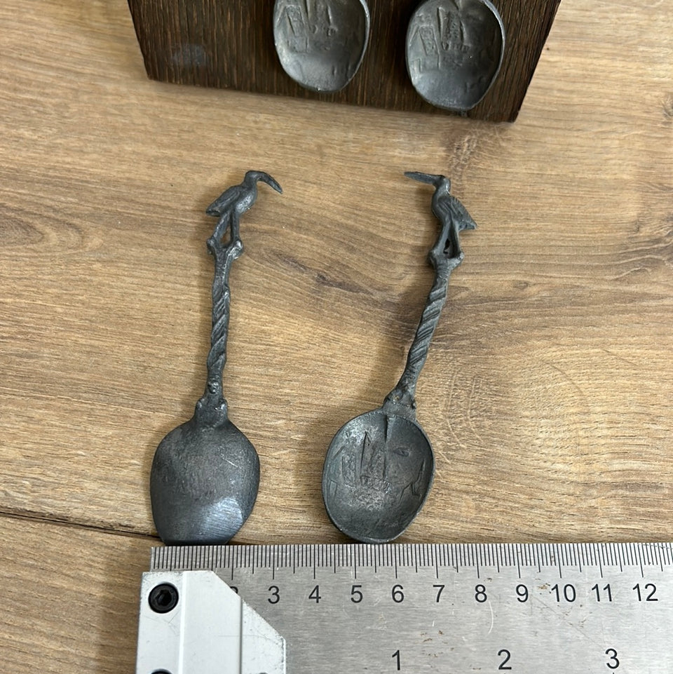 Antique wooden wall hanging with 6 old small Dutch tin spoons.