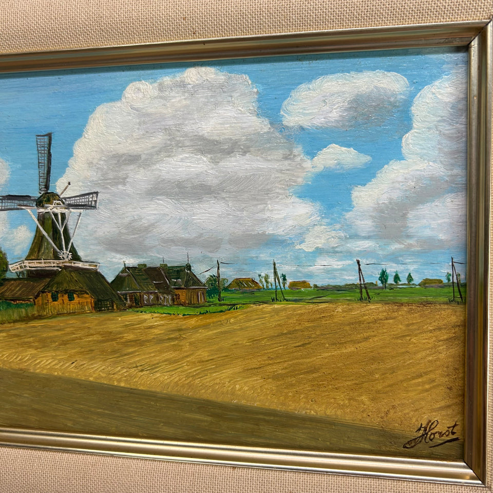 Dutch landscape Holwerd “Monnikmolen” with windmill and blue sky