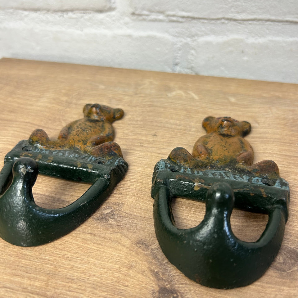 Antique cast-iron hangers with teddy bear for children’s room
