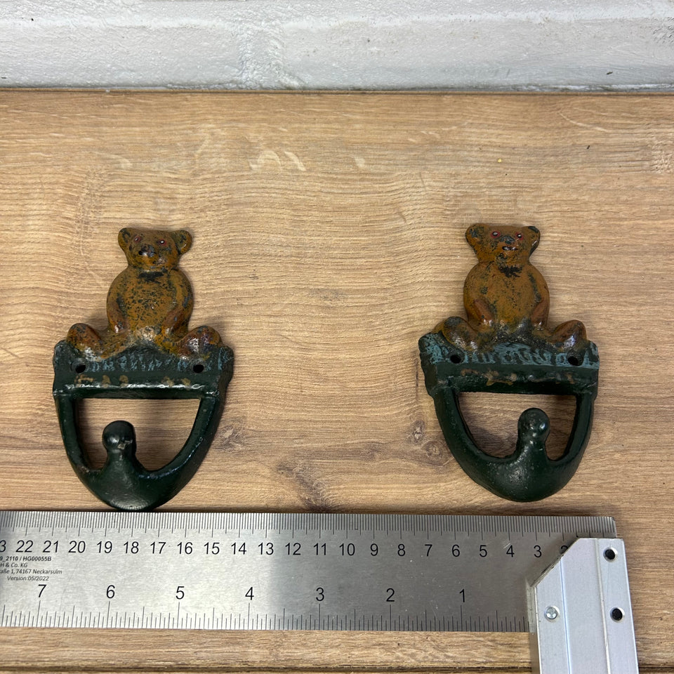 Antique cast-iron hangers with teddy bear for children’s room