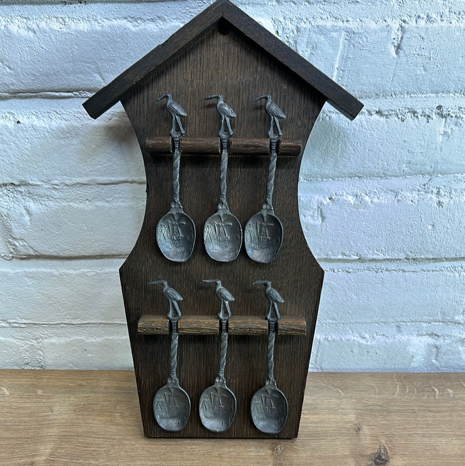 Antique wooden wall hanging with 6 old small Dutch tin spoons.