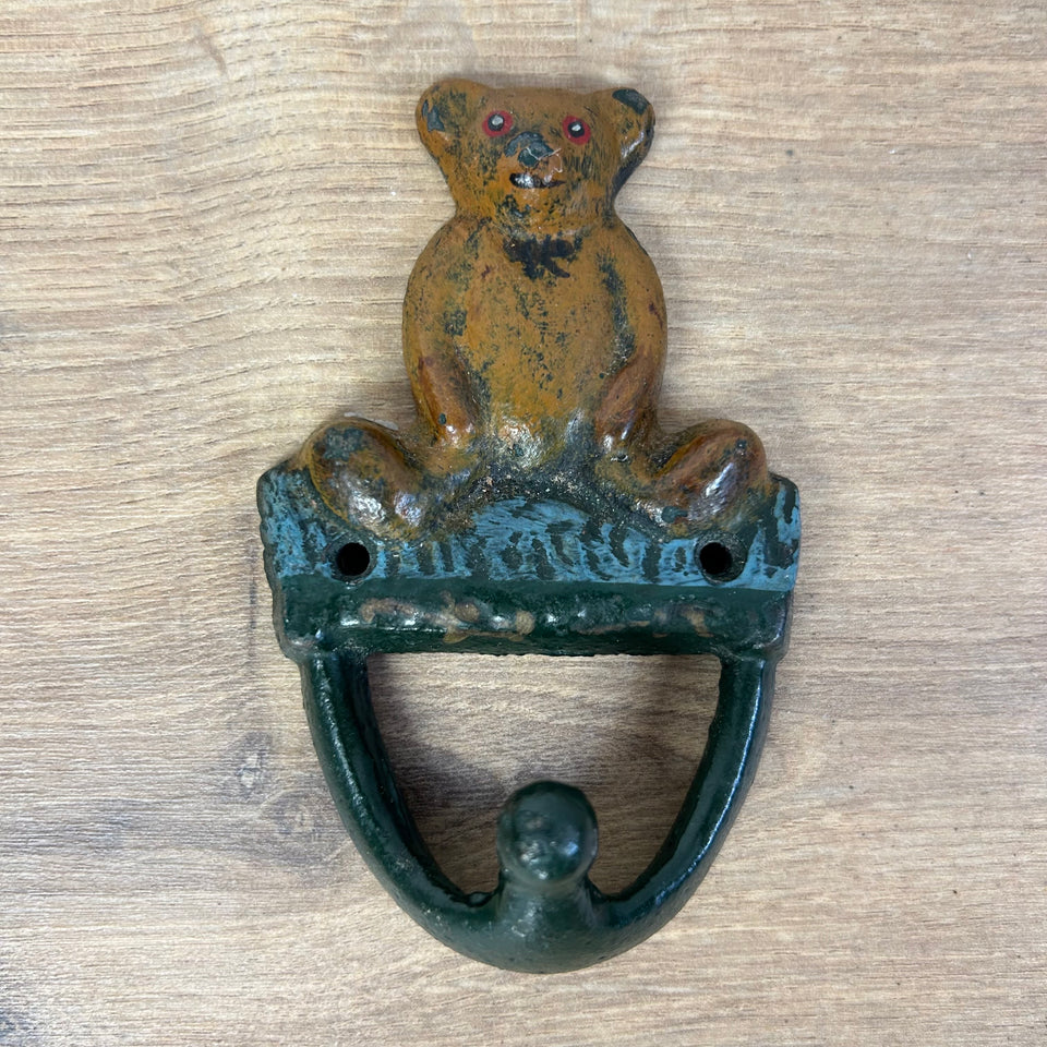 Antique cast-iron hangers with teddy bear for children’s room