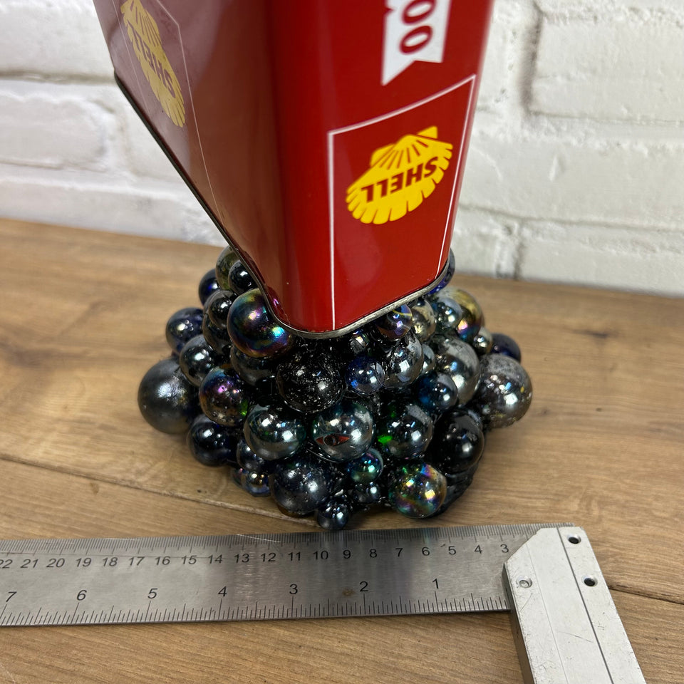 Shell oil can pouring Marbles statue