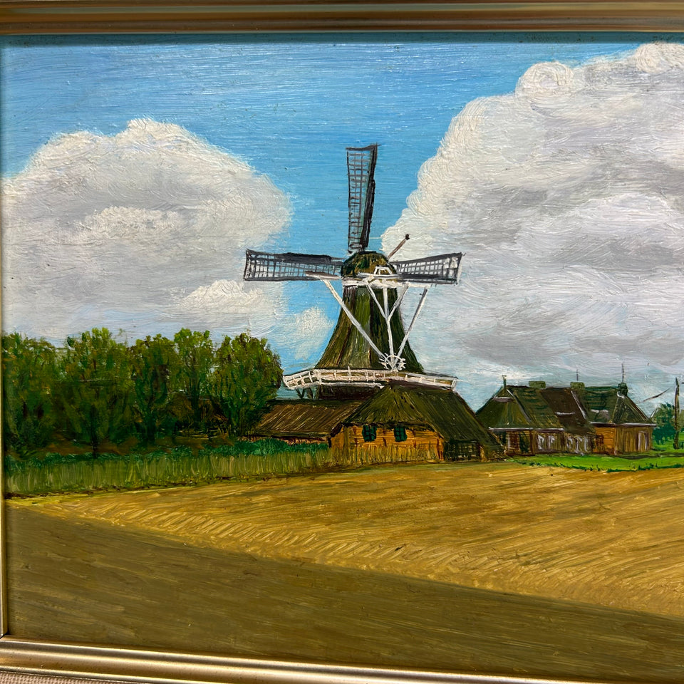 Dutch landscape Holwerd “Monnikmolen” with windmill and blue sky