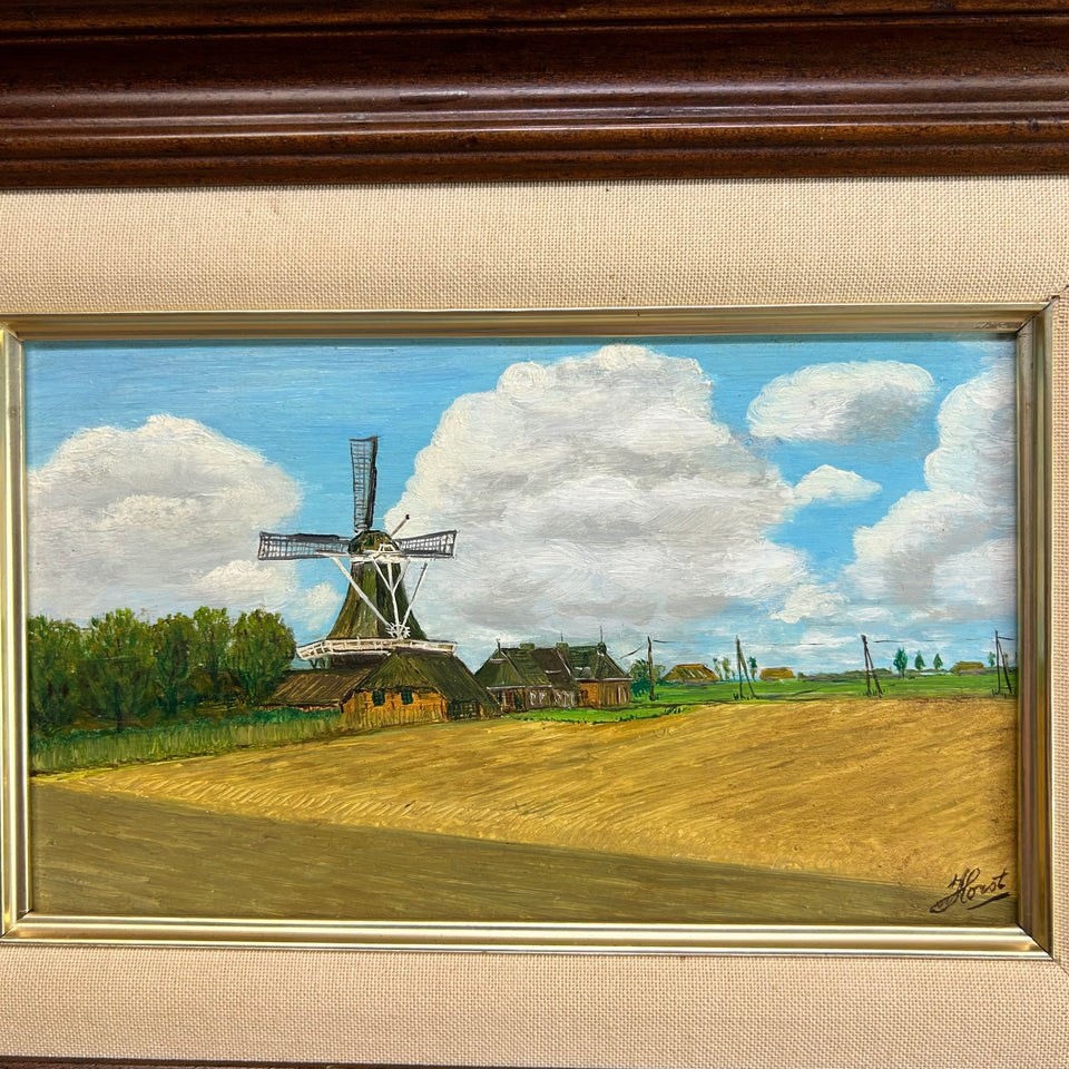 Dutch landscape Holwerd “Monnikmolen” with windmill and blue sky