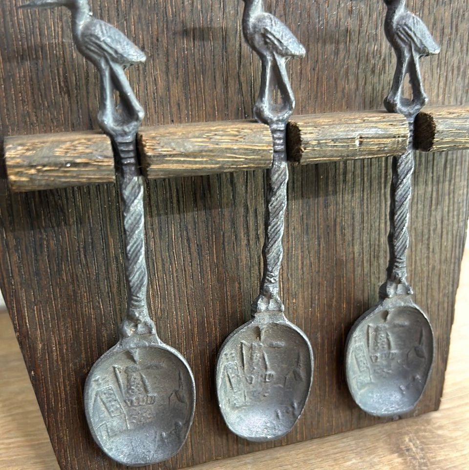 Antique wooden wall hanging with 6 old small Dutch tin spoons.