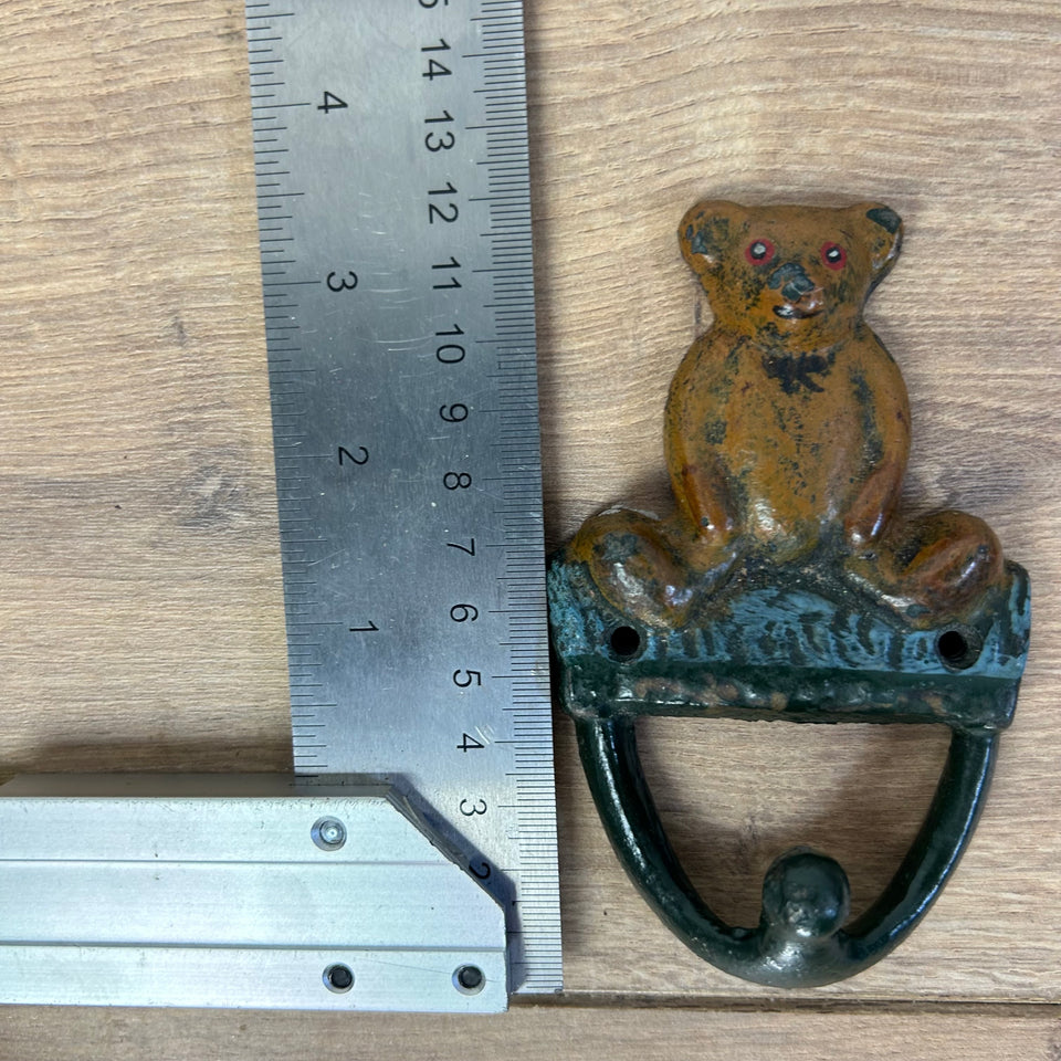 Antique cast-iron hangers with teddy bear for children’s room