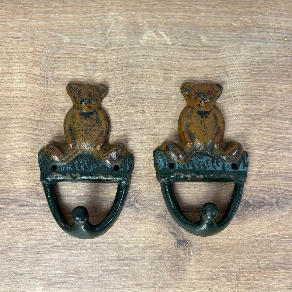 Antique cast-iron hangers with teddy bear for children’s room