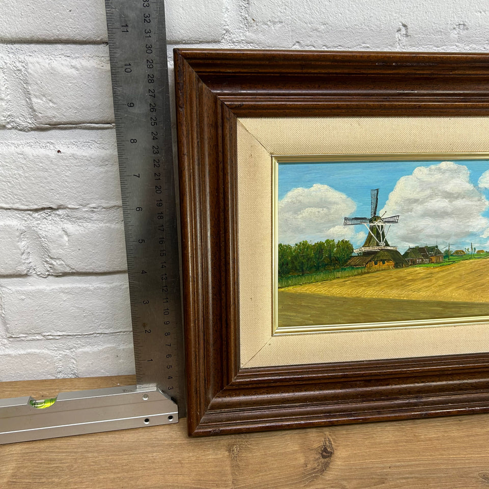 Dutch landscape Holwerd “Monnikmolen” with windmill and blue sky