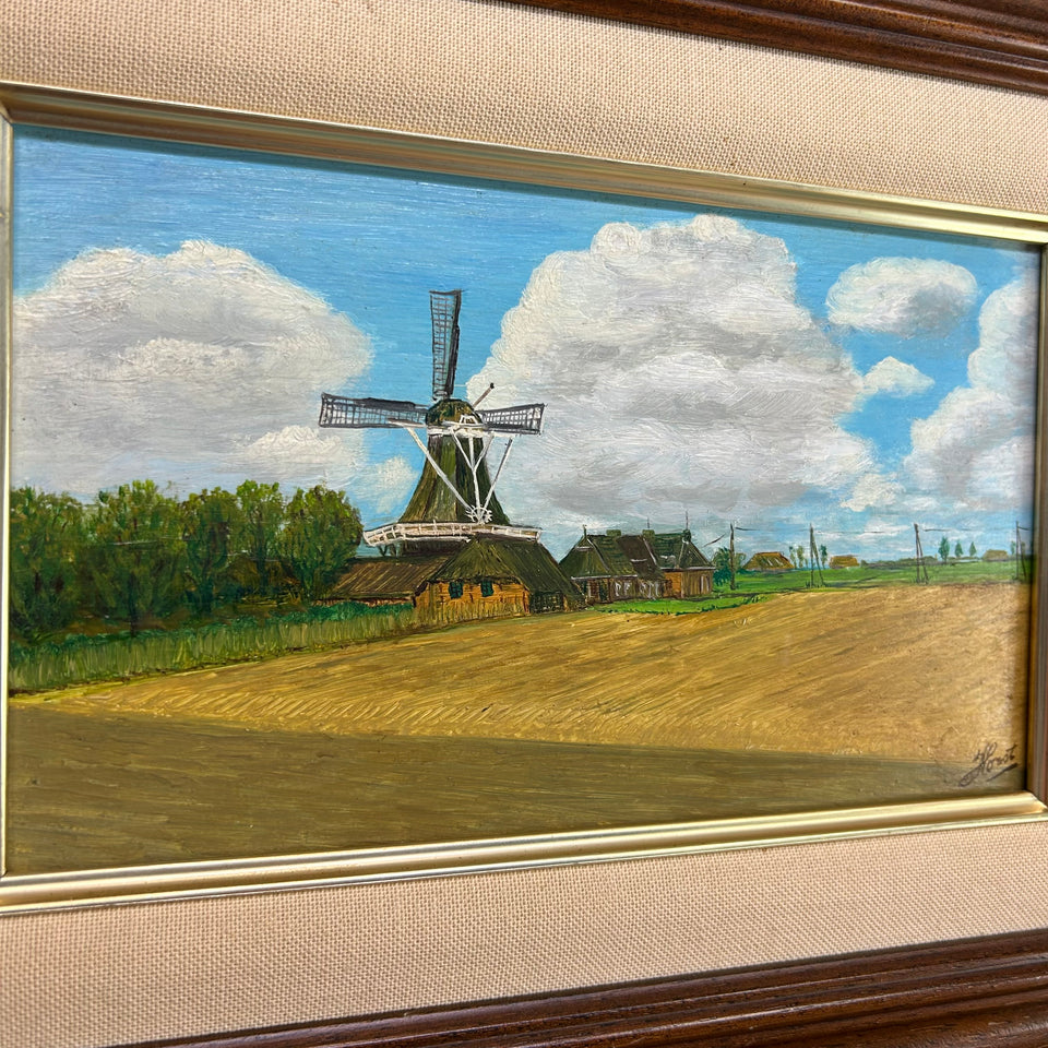 Dutch landscape Holwerd “Monnikmolen” with windmill and blue sky