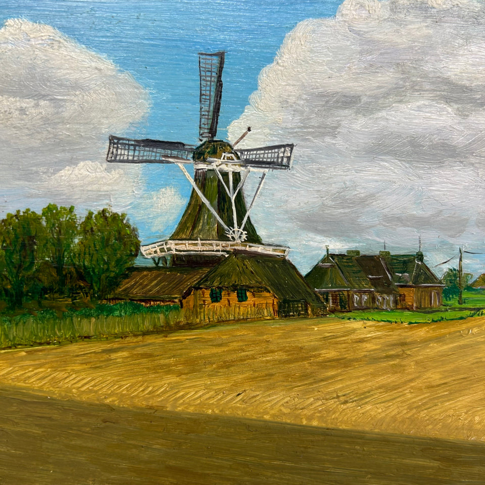 Dutch landscape Holwerd “Monnikmolen” with windmill and blue sky