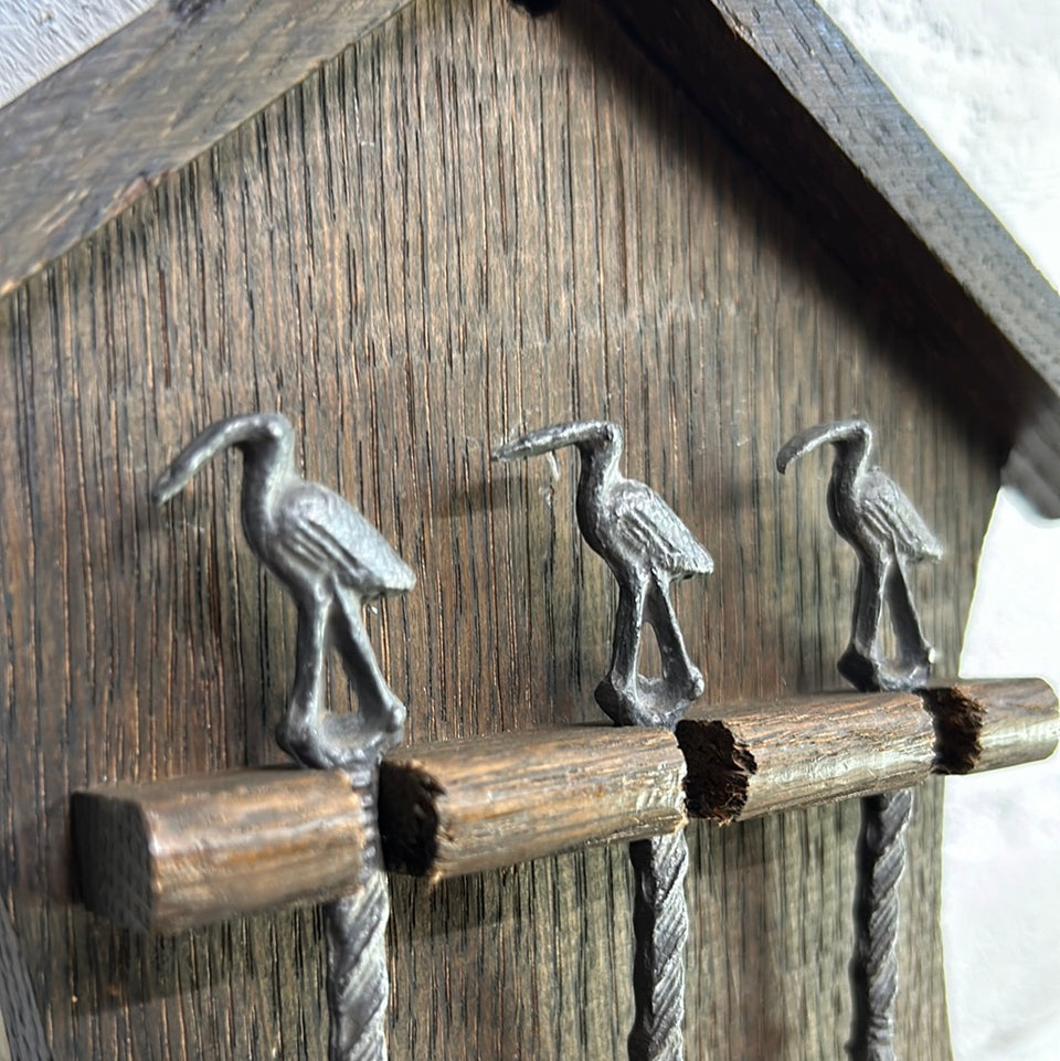 Antique wooden wall hanging with 6 old small Dutch tin spoons.