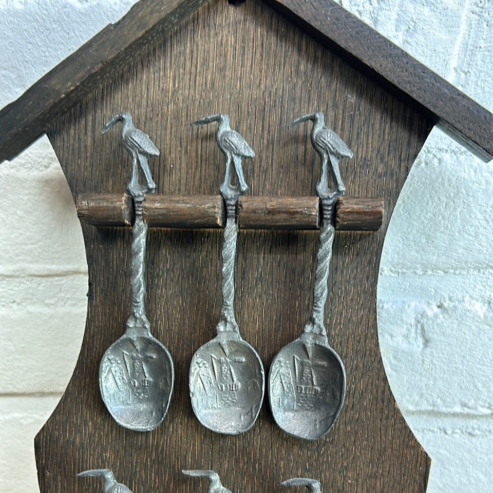 Antique wooden wall hanging with 6 old small Dutch tin spoons.