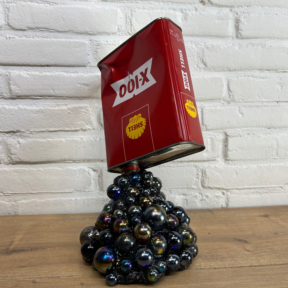 Shell oil can pouring Marbles statue