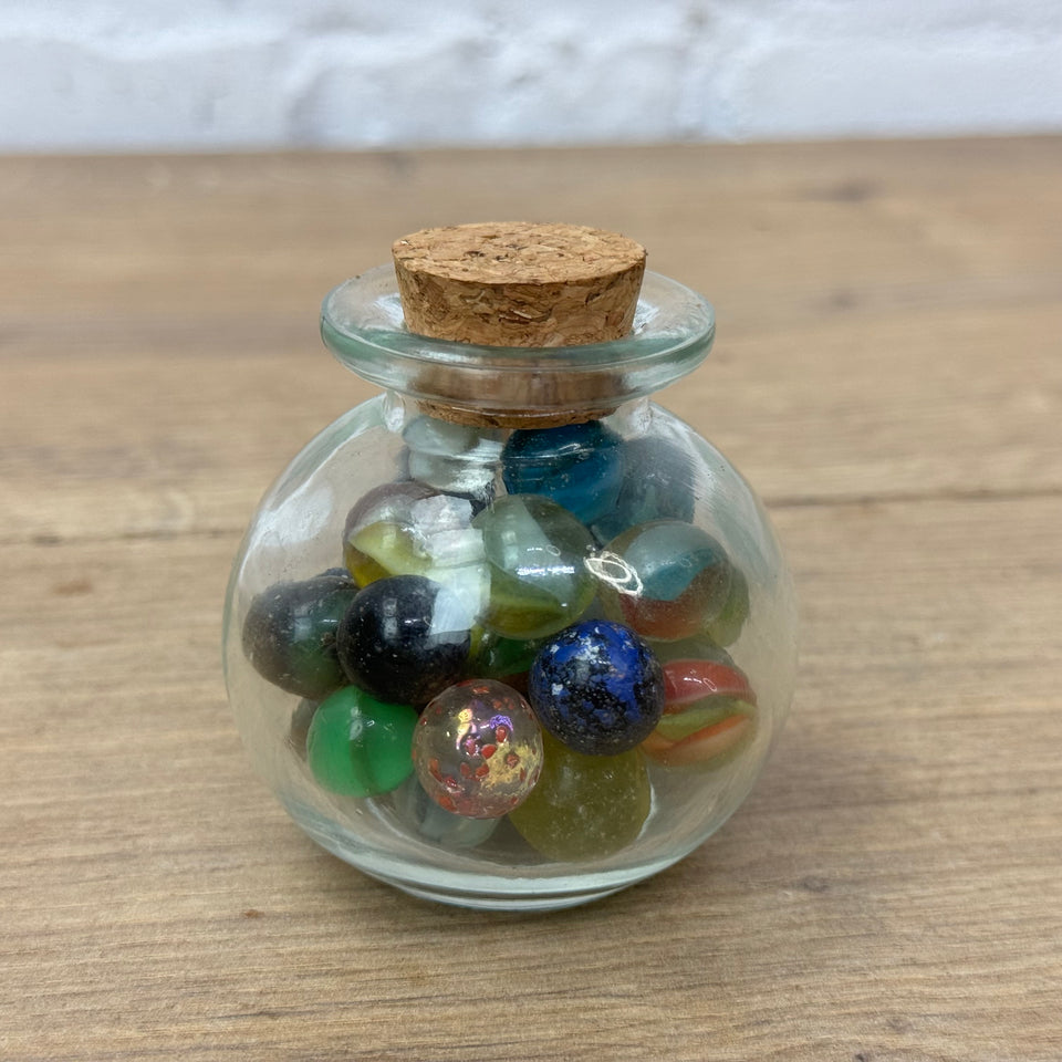 A miniature jar with mixed antique and vintage peewee mini marbles