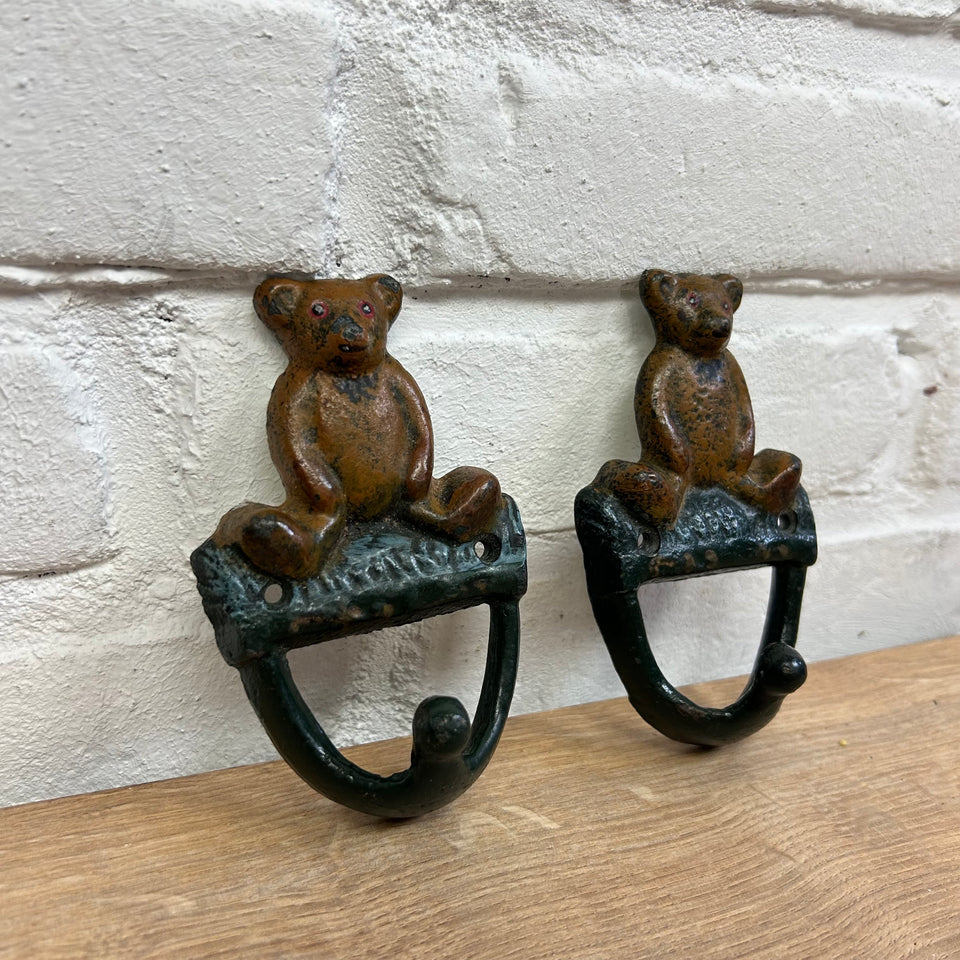 Antique cast-iron hangers with teddy bear for children’s room
