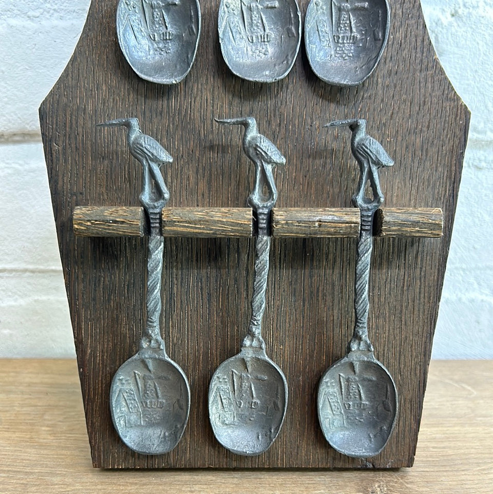 Antique wooden wall hanging with 6 old small Dutch tin spoons.