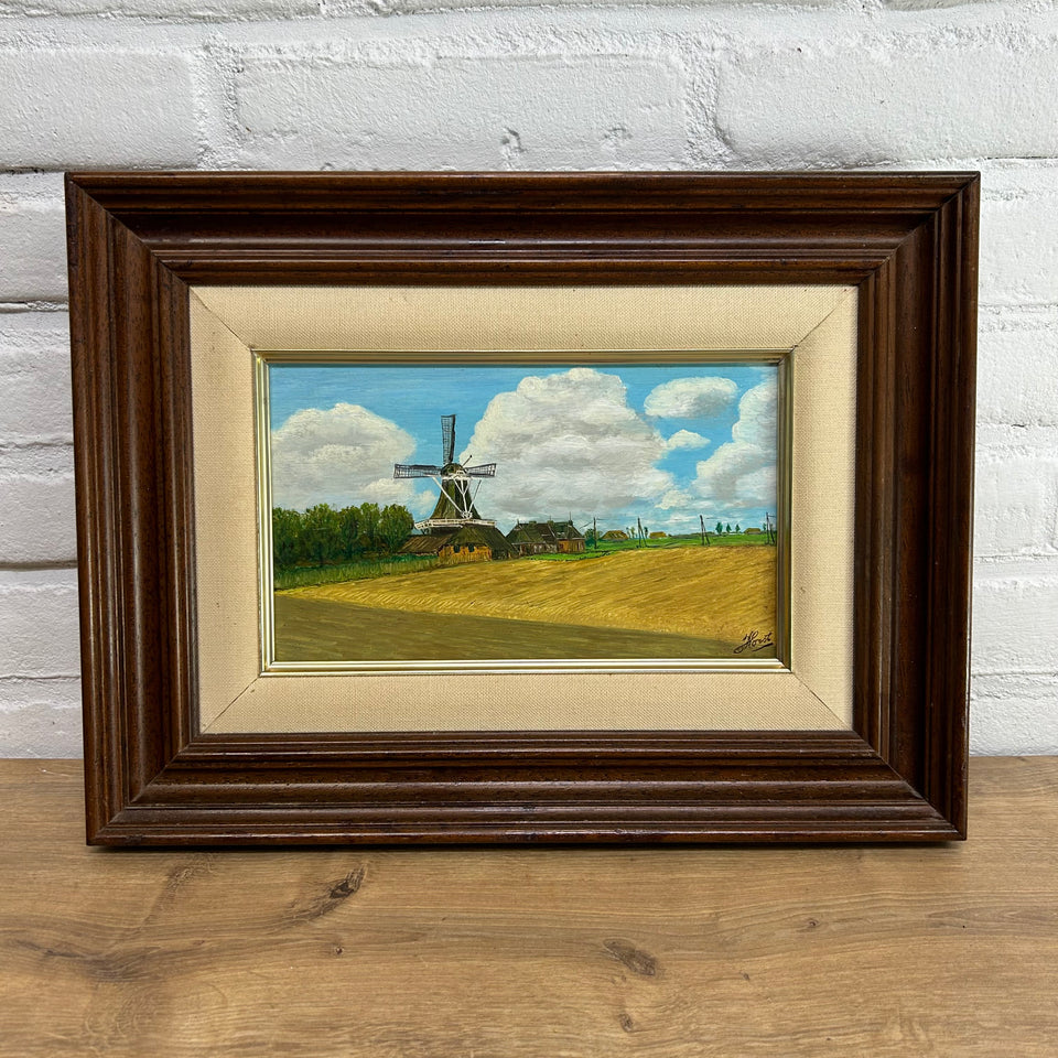 Dutch landscape Holwerd “Monnikmolen” with windmill and blue sky