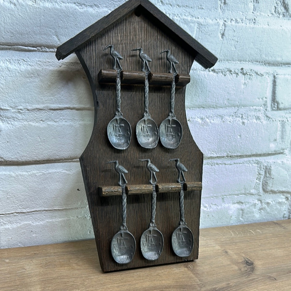 Antique wooden wall hanging with 6 old small Dutch tin spoons.