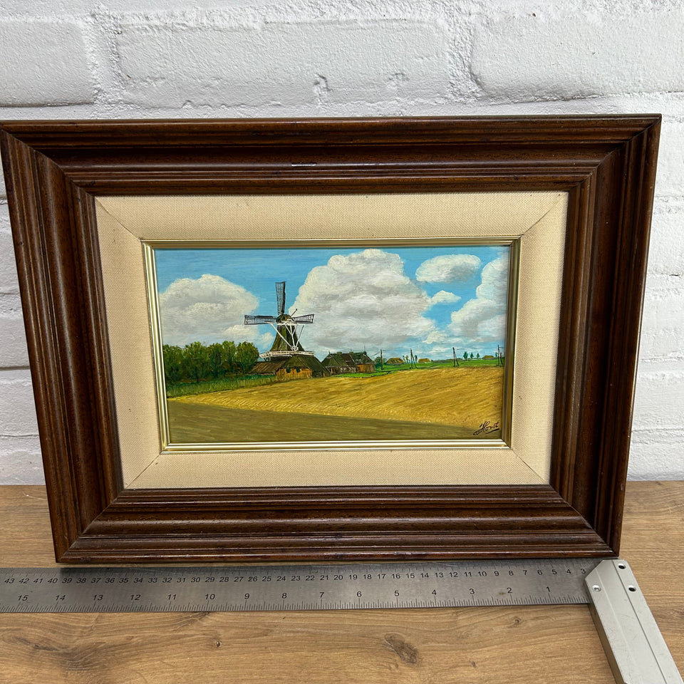 Dutch landscape Holwerd “Monnikmolen” with windmill and blue sky