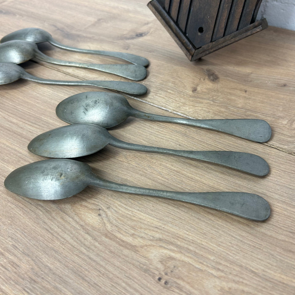 Antique wooden wall display with 6 old tin spoons.